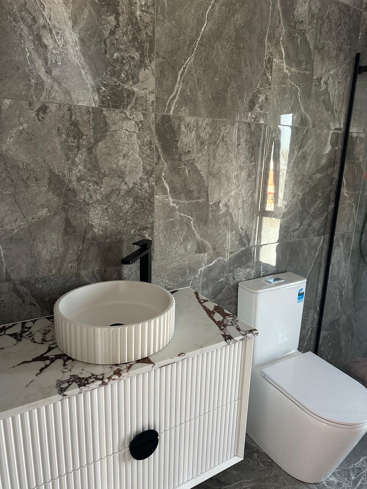 Detail shot of textured vanity and premium fixtures